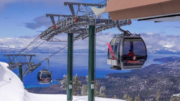 Heavenly Gondola cabins glide above Lake Tahoe with panoramic mountain views in winter.